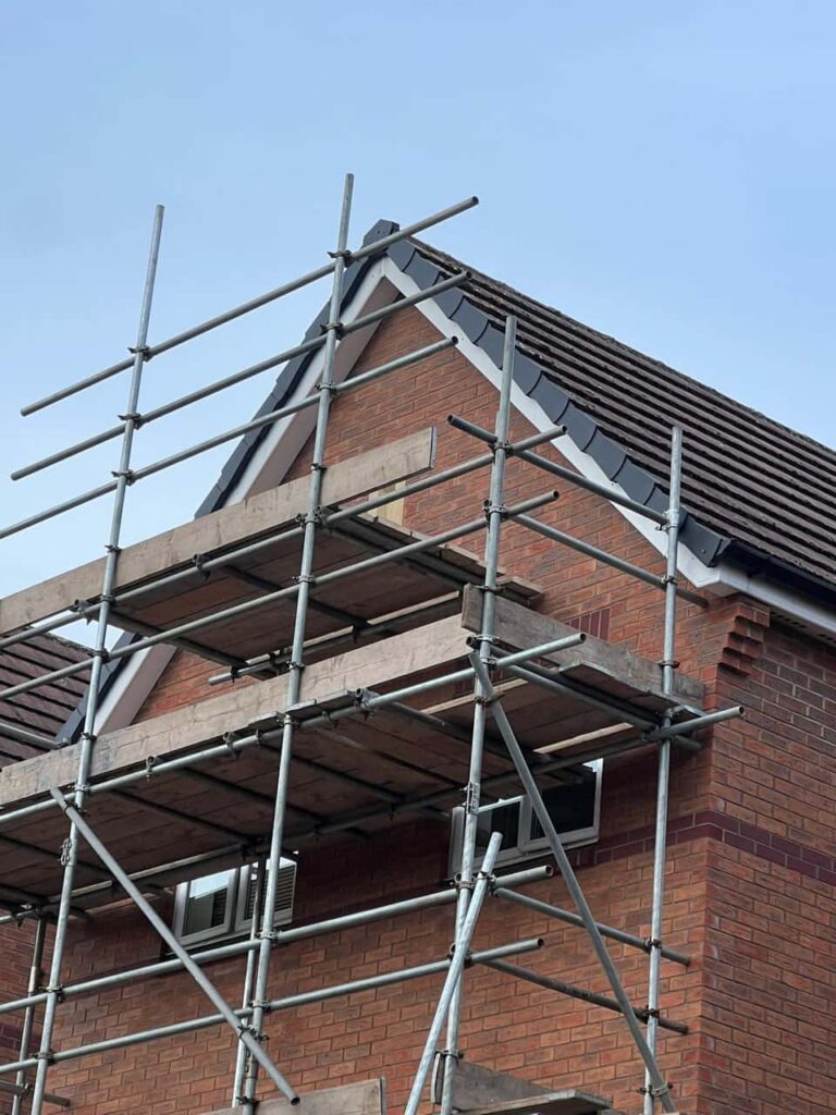 This is a photo of a roof which has just been repaired. There is a scaffold located at the gable end for access onto the roof. Works carried out by Brierley Hill Roofing Repairs