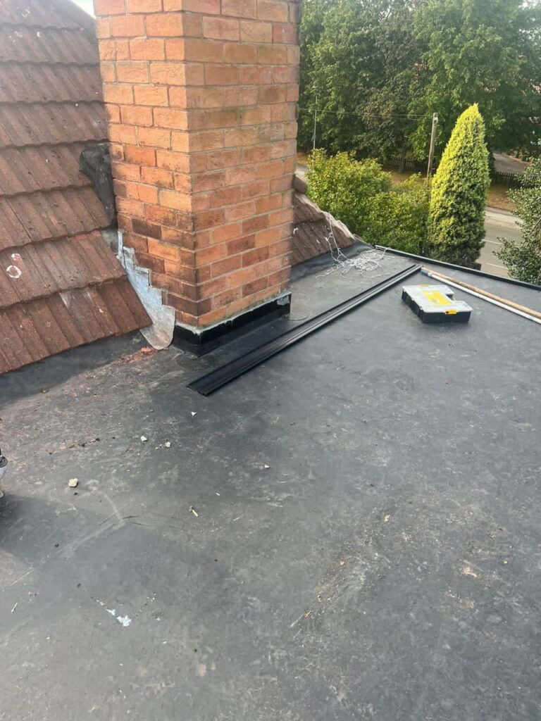 This is a photo of a flat roof which has just been repaired, there is also a chimney stack and some leadwork has also been dressed. Works carried out by Brierley Hill Roofing Repairs
